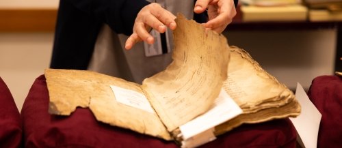A researcher examines a centuries-old Ottoman manuscript in Yale's Bienecke library