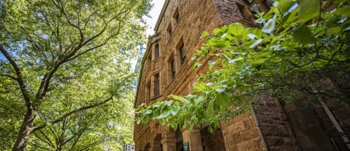 Warner House, a brownstone building on Hillhouse Avenue in New Haven, surrounded by greenery