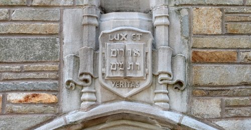 The Yale motto, Lux et Veritas, carved in stone above an archway.