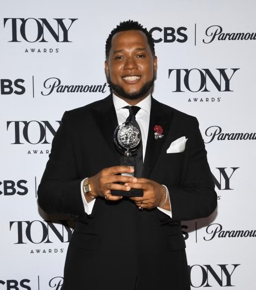 Branden Jacobs-Jenkins poses with the Tony award he won on June 8, 2025, for his play "Purpose." Photo courtesy: Evan Agostini / AP