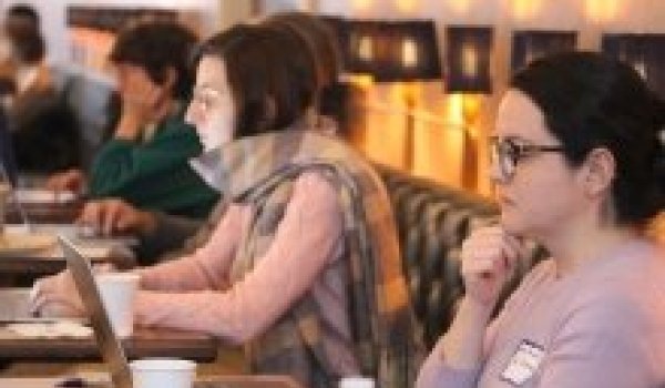 Faculty writing at a retreat