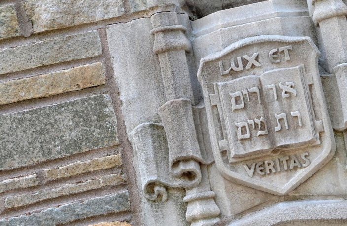 Stone carving of Yale coat of arms saying "Lux et Veritas"