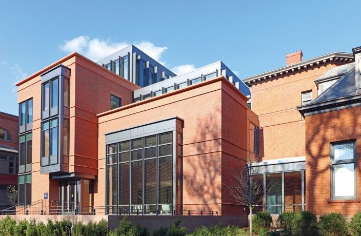 A modern red brick building with large windows