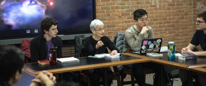 Professor Ruth Yeazell sits at a seminar table with Directed Studies students.