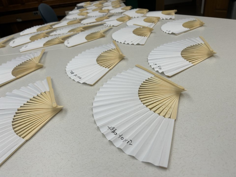 Lee-Smith handwrote the Korean translation of the names of each participant on paper fans. Photo credit: Michaela Herrmann.