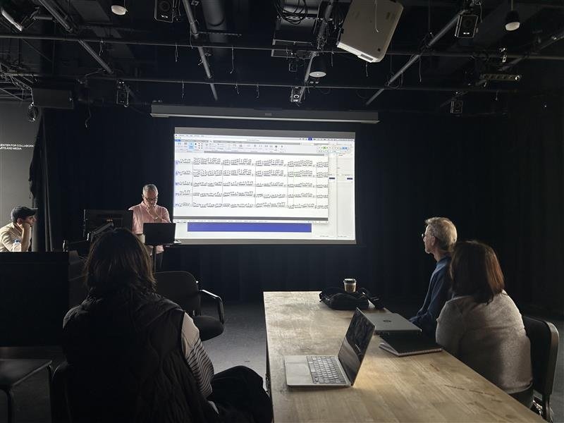 Suttor and FAS faculty sit in a dark room as they listen to a musical piece inspired by nature, generated by AI, and edited by his Yale College students. Photo credit: Michaela Herrmann.
