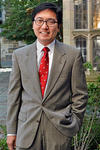 Portrait of Marvin Chun, sporting a red, Berkley College tie. 