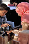 A young Syrian refugee performs tests with a researcher