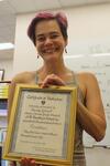  Wendy Gilbert holding up her second-grade certificate of distinction 