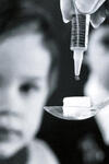 Image: Polio vaccine dropped on to sugar cube for child.